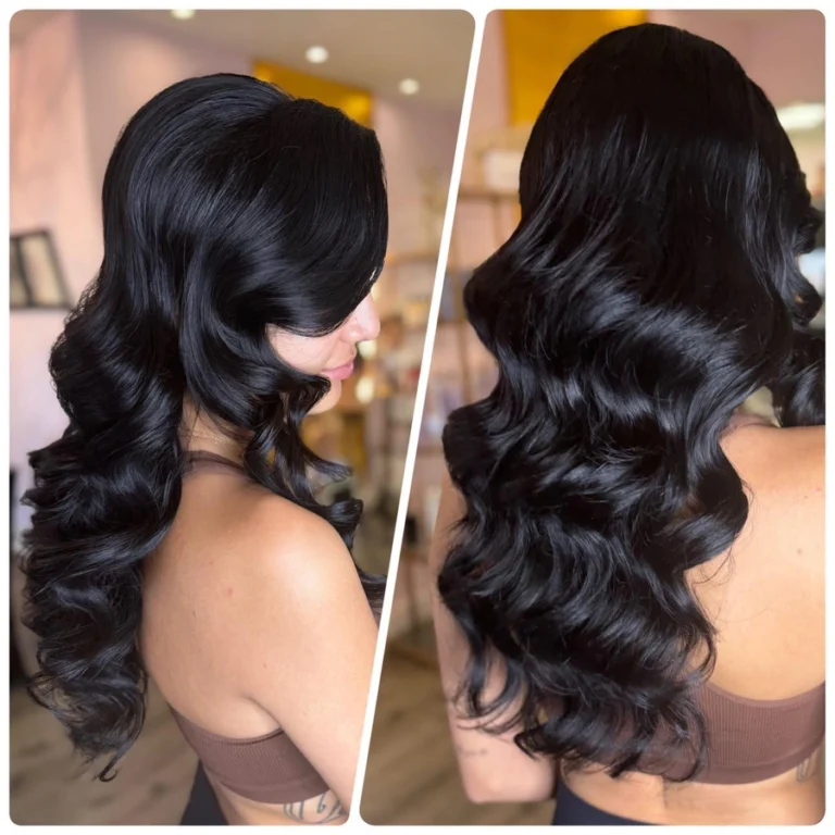Bride with long, shiny black Hollywood waves and soft retro curls styled for a glamorous wedding look.