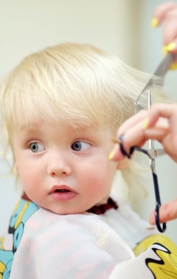 Young child getting a professional haircut at Dettycated salon in Porter Ranch